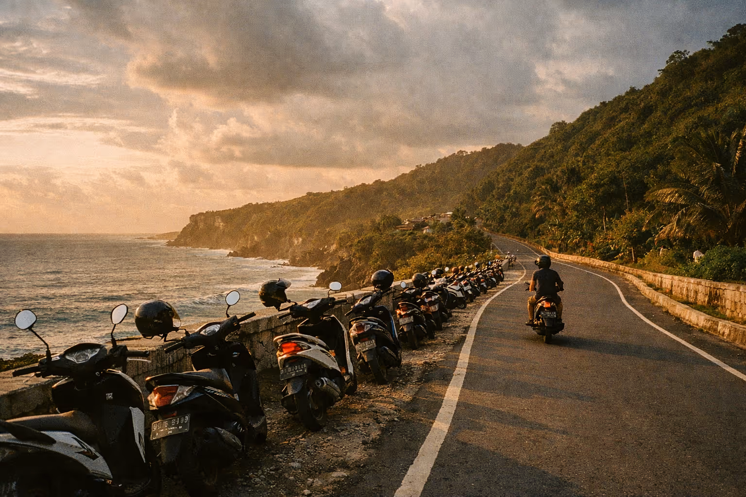 Coastal Bali at golden hour with scooters along a winding road