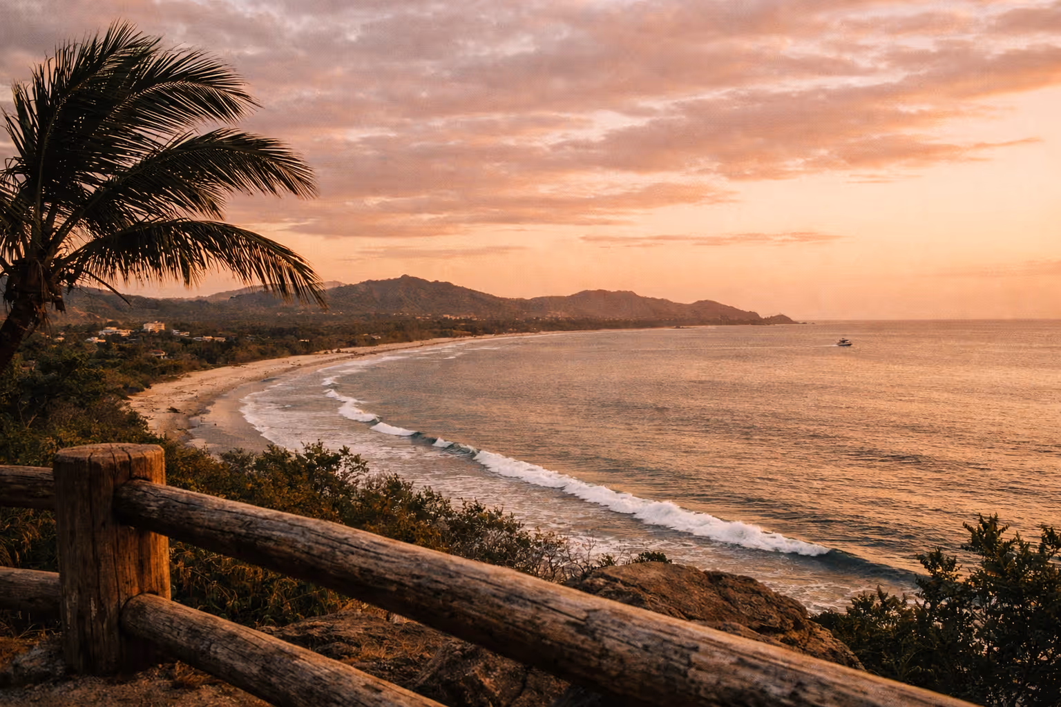 Editorial panorama of Tamarindo coastline at golden hour with palm silhouettes and distant surfers