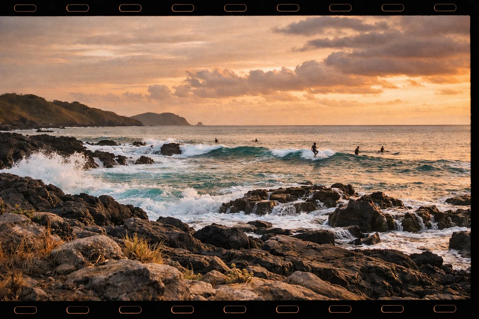 Guanacaste coastline at golden hour with distant volcano silhouette and rugged rocks
